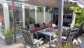 geschützte Terrasse mit Pavillon und dem Wintergarten im Hintergrund